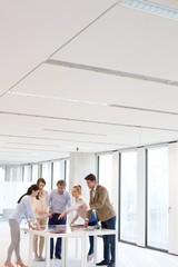 Team of business people having discussion at table in office