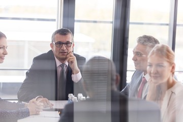 Multi-ethnic business people having discussion in board room at office