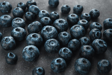  Ripe blueberries on a dark gray rough background. Harvest blueberries. Blue berry background.