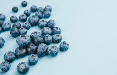  Ripe blueberries on a blue wooden background copy space. Harvest blueberries. Blue berry background.