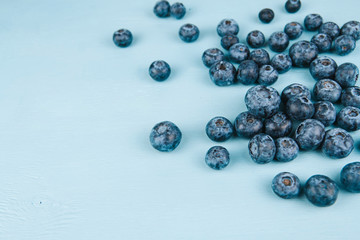 Ripe blueberries on a blue wooden background copy space. Harvest blueberries. Blue berry background.