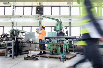 Manual worker operating machinery at metal industry