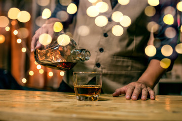 Barman pouring whiskey whiskey glass beautiful night