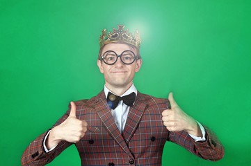 Young man in suit showing thumbs up sign