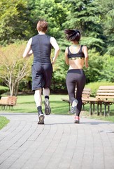 Fototapeta premium Young couple running in the park