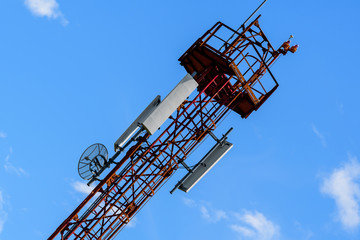 Telecommunications antennas on the telecommunications tower with clear blue sky in the background