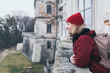 Woman in red coat enjoying the view at Pidhirtsi Castle in Lviv region, Ukraine