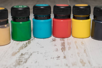 A set of multi-colored cans of paint for drawing