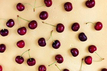 Naklejka na ściany i meble Close up of ripe cherry on golden background.