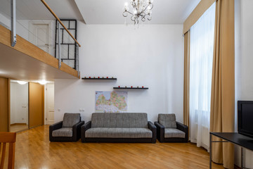 Modern interior of studio apartment. Wooden table. Cozy couch.