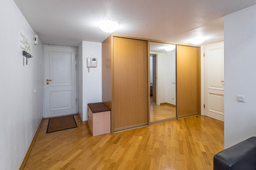 Entrance hall in private house. Wardrobe with mirror.