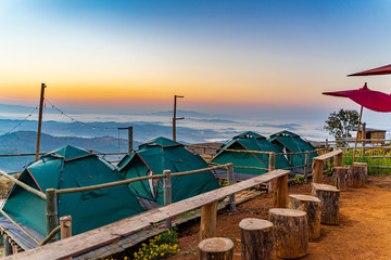 Camping and green tent on the hill with morning misty mountain at Ban Doi Sa-ngo Chiangsaen...