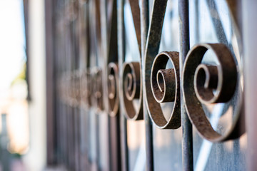 Close up of rusty gate with decorative swirls