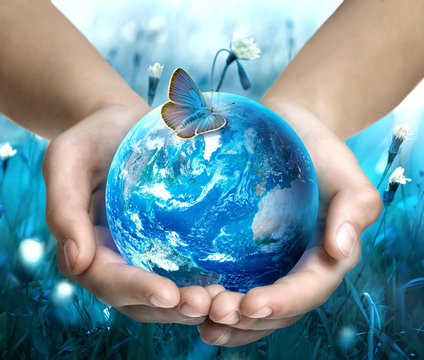 Earth in hands on blue nature background. Ecology concept. Save of Earth. World Earth day. Elements of this image are furnished by NASA