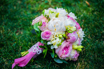 wedding bouquet with wild flowers. peonies on the grass