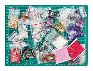 various embroidery items on cutting mat isolated