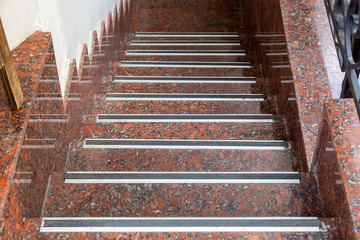 marble staircase with rubber non-slip strips down to the basement, close up nobody.