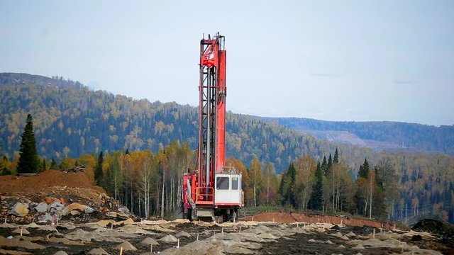 A wide panorama drilling machine makes wells for the explosives. Preparing a quarry for coal mining
