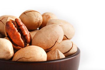 Pecan in a wooden Cup isolated on a white background. Isolate.