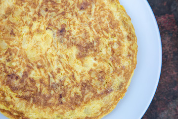 Spanish home made tortilla de patatas spanish potato omelette tapa tapas delicious food on a rusty table