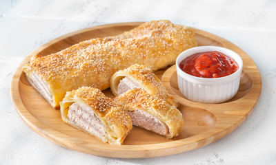 Sausage rolls with tomato sauce