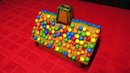 a home-made gingerbread house with the roof covered with chocolates