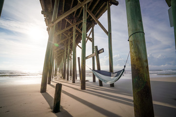 pier with hammock at sunset