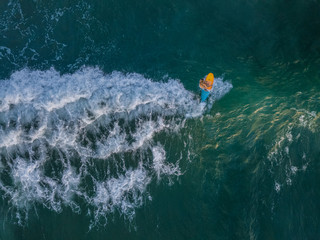 Overhead aerial of surfer on waves