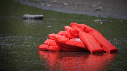 red safety vests for kayak on the lake