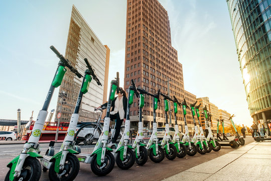 Row of electric E scooters , escooter or e-scooter of the company LIME  - Berlin, Germany, October, 2019