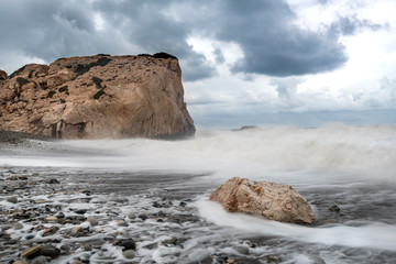 Seascape with windy waves during storm weather a  rocky coastline
