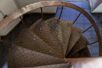 Upside view of a spiral staircase pattern. Spiral stairs circle in old courtyard architecture.