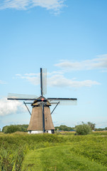 Fototapeta na wymiar Historical mill in Dutch landscape