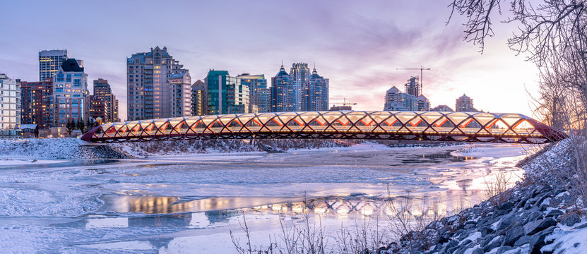 Evening skyline view along the Bow River in Calgary, Alberta.  Peace Bridge visible. 