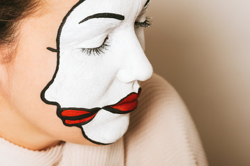 Woman actress with double face makeup studio portrait