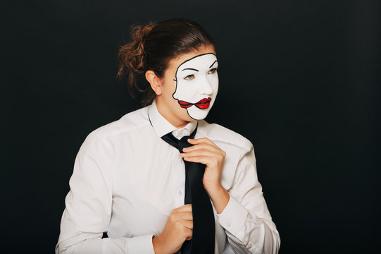 Woman actress with double face makeup studio portrait