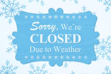Naklejka na ściany i meble Sorry We're Closed Due to Weather message on a wood sign