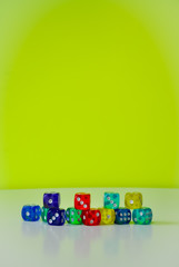 colorful dices in white and green background