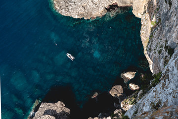 Boat in a bay with a freediver in Mallorca, Spain