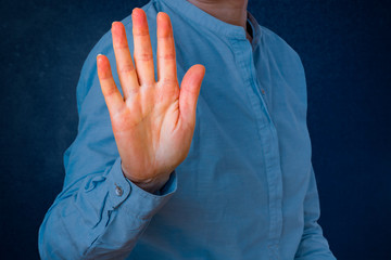 Woman signals defensive attitude with hand