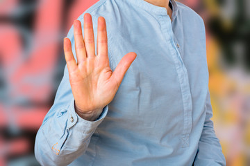 Woman signals defensive attitude with hand