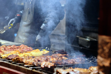 Street food at the main city fair Kebab, corn, grilled sausages.