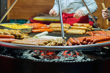 Street food at the main city fair Kebab, corn, grilled sausages.