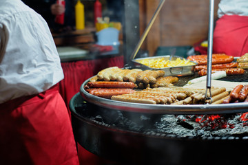 Street food at the main city fair Kebab, corn, grilled sausages.