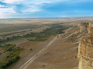 View from the top of the mountain White Rock of Ak-Kaya, overlooking the valley and the village populating it, on a sleepy day with clouds in the sky