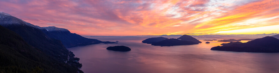 Tunnel Bluffs Hike, in Howe Sound, North of Vancouver, British Columbia, Canada. Panoramic Canadian Mountain Landscape View from the Peak during sunny winter sunset.