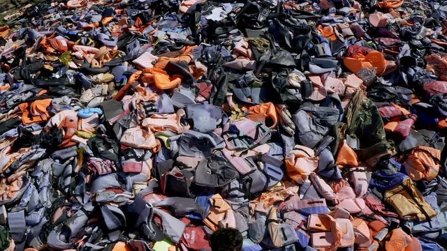 Aerial of Graveyard of lifejackets of hundreds of thousands refugees in Molyvos Greece, Lesvos