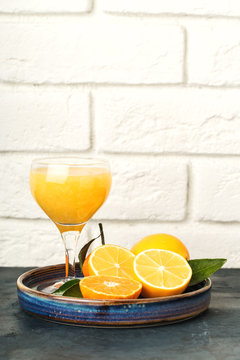 Still life of citrus fruit, fresh juice in a glass.