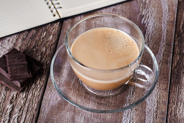 Coffee in a cup with note book.