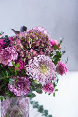 Bouquet of aster, peony roses, carnations and other pink flowers